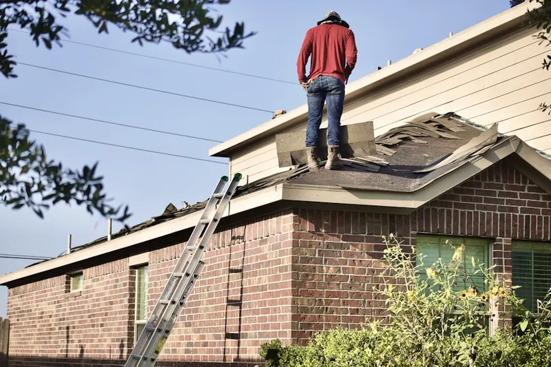 Professional roofer working on a residential roof in Bay Wood